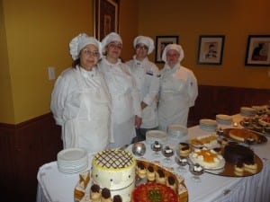 Triton College Culinary Students standing in front of their delicious desserts