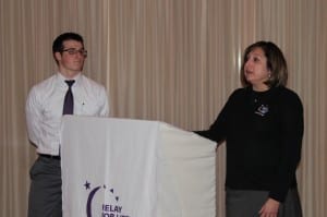 Carol Figarelli, Cancer Survivor and Team Captain of Figarelli Fighters, accompanied by her son, tells the audience of her journey through cancer. 